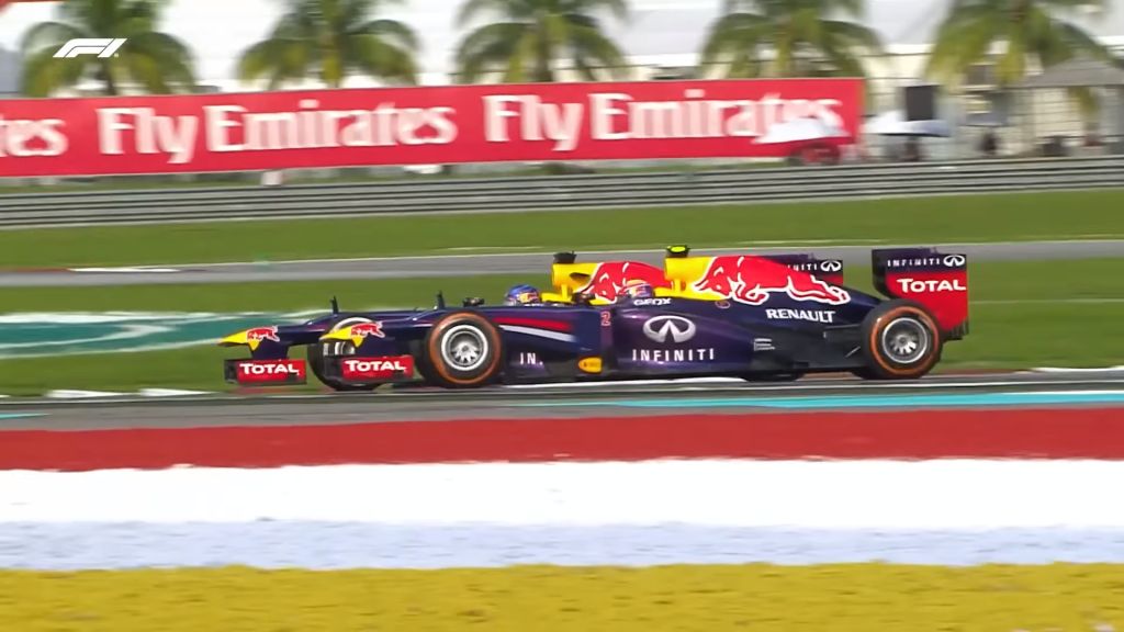 Sebastian Vettel overtakes George Russell at the 2013 Malaysian Grand Prix.